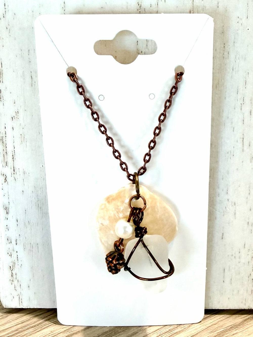 109. Jingle shell necklace with White Sea glass and a pine cove charm